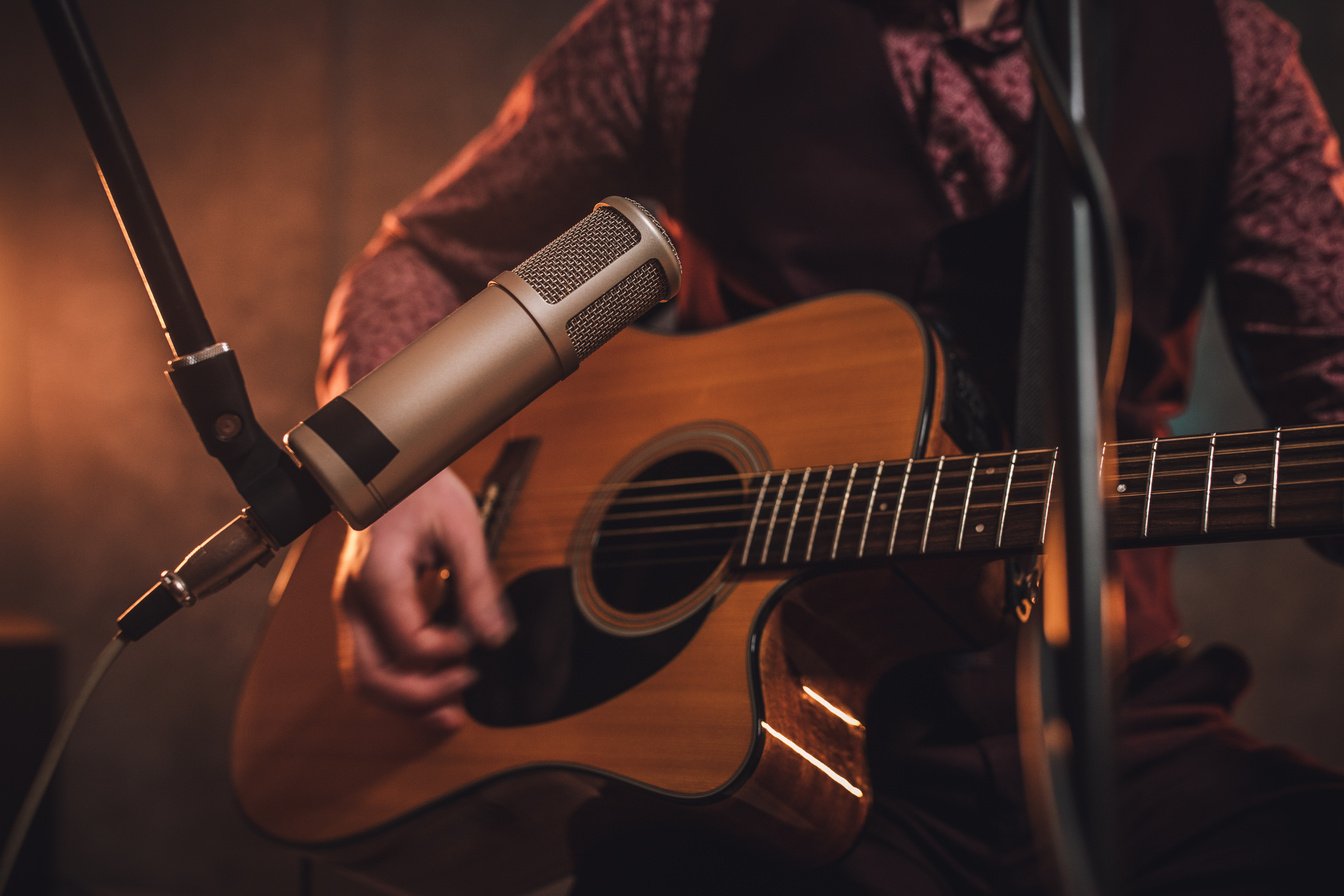 Rock musician playing acoustic guitar