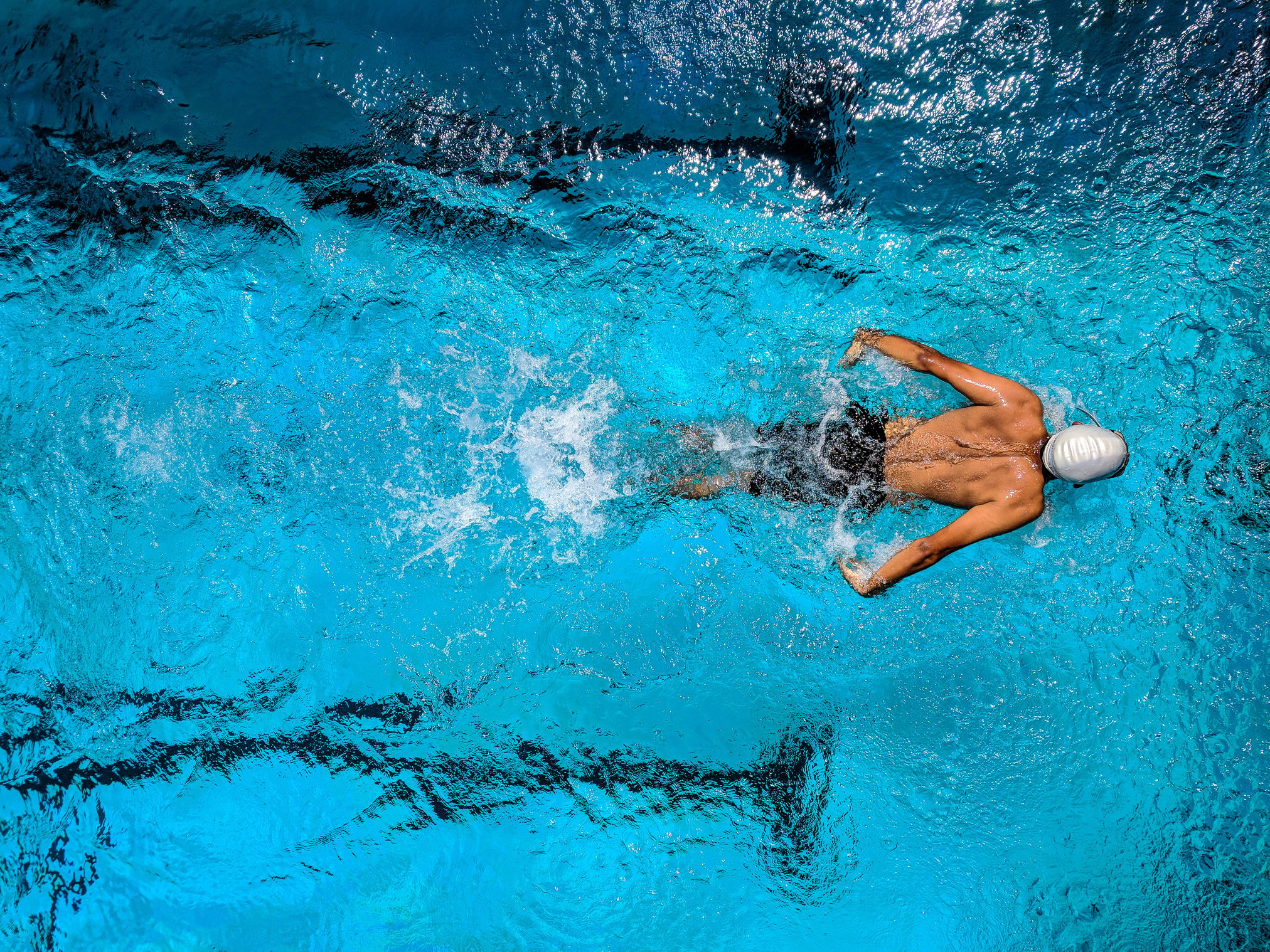 Person Swimming on Body of Water